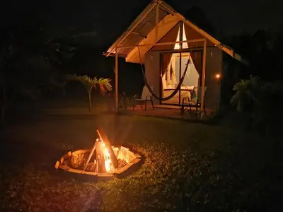 a fire pit in front of a tent at night at Tiny House Dreamcatcher in Sarchí Sur