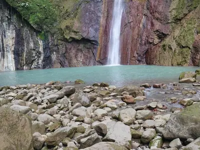 a waterfall in a canyon with a pool of water at Tiny House Dreamcatcher in Sarchí Sur