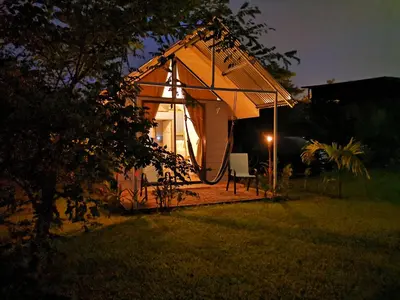 a small tent in a yard at night at Tiny House Dreamcatcher in Sarchí Sur