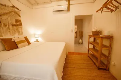 a bedroom with a large white bed in a room at Tribe Boutique Hotel - Adults Only in Dominical