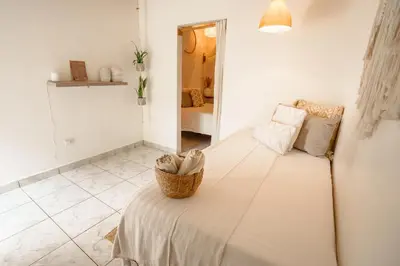 a bedroom with a bed with a basket on it at Tribe Boutique Hotel - Adults Only in Dominical