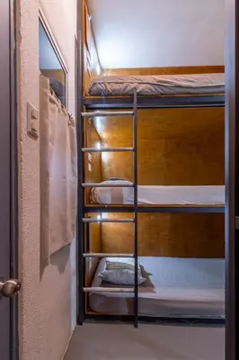 a couple of bunk beds in a room at Akih Pods Hostel in Santa Teresa Beach