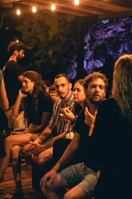 a group of people sitting in a room at Akih Pods Hostel in Santa Teresa Beach