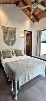 a bedroom with a large bed in a room at Lapislazuli House & Flats with shared Pool in Santa Teresa Beach