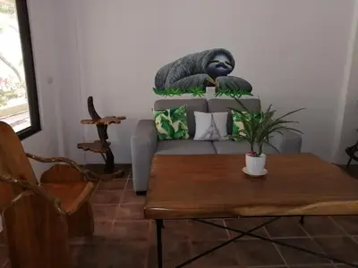 a living room with a couch and a table at La Sirena Playa Jacó in Jacó