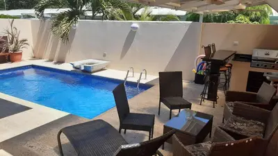 a swimming pool with chairs and a table and a piano at Malaga Herradura 25 with Private Pool in Herradura