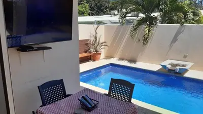 a swimming pool with two chairs and a tv next to it at Malaga Herradura 25 with Private Pool in Herradura