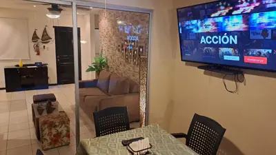 a living room with a table and a tv on the wall at Malaga Herradura 25 with Private Pool in Herradura