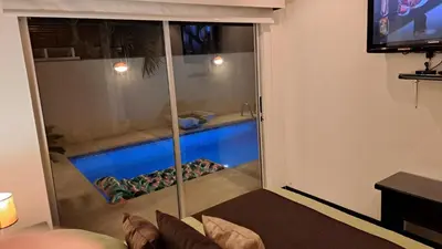 a living room with a swimming pool seen through a glass door at Malaga Herradura 25 with Private Pool in Herradura