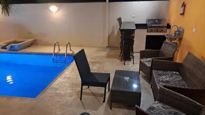 a swimming pool in a room with chairs and a table at Malaga Herradura 25 with Private Pool in Herradura