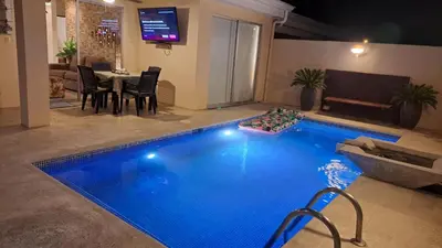a swimming pool in a living room with a dining table at Malaga Herradura 25 with Private Pool in Herradura