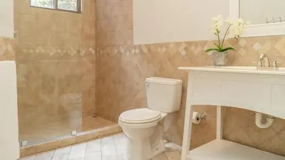 a bathroom with a toilet and a shower and a sink at Bright 2BR Condo with Partial Ocean View - Bougainvillea - Reserva Conchal in Playa Conchal