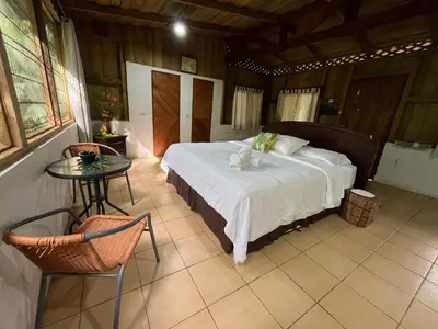 a bedroom with a bed and a table in a room at El Zota Hotel in Cariari