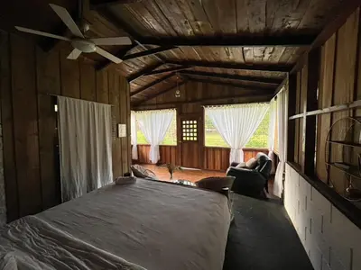 a bedroom with a large bed in a house at El Zota Hotel in Cariari