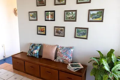 a bench in a room with pictures on the wall at Hostel Bouganvilia Bed and Breakfast in San Ramón