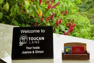 a sign that says welcome to the toucan lane at Toucan Lane in Nuevo Arenal