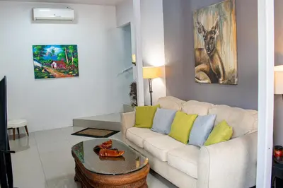 a living room with a couch and a table at Toucan Lane in Nuevo Arenal
