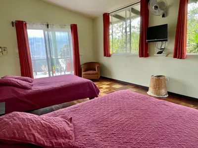 a bedroom with two beds and a window at Rinconcito Verde in Ujarrás