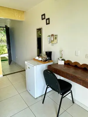 a kitchen with a white refrigerator and a chair at Rinconcito Verde in Ujarrás