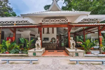 a house with two statues in front of it at Hotel Verde Mar Direct Beach Access in Manuel Antonio