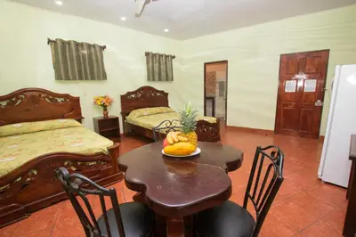 a room with a table with a bowl of fruit on it at Hotel Verde Mar Direct Beach Access in Manuel Antonio