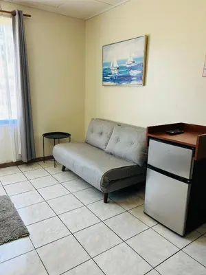 a living room with a couch and a table at Hotel Laura's House in Coco