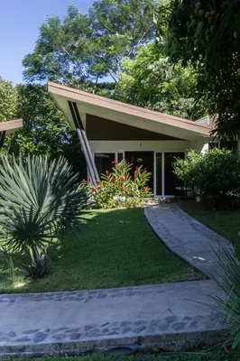 a house with a walkway in front of it at Guácima Escondida Hotel Boutique in Guácima