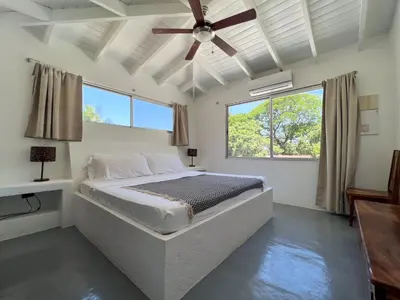 a bedroom with a bed and a ceiling fan at Salt Nosara in Nosara
