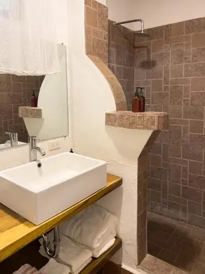 a bathroom with a white sink and a shower at Salt Nosara in Nosara
