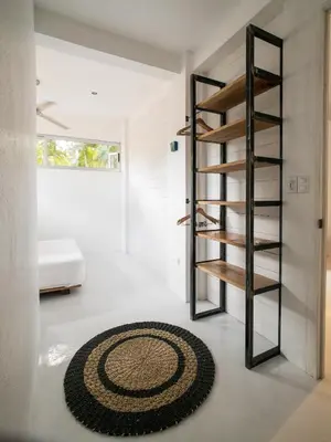 a room with a spiral staircase and a rug at Salt Nosara in Nosara