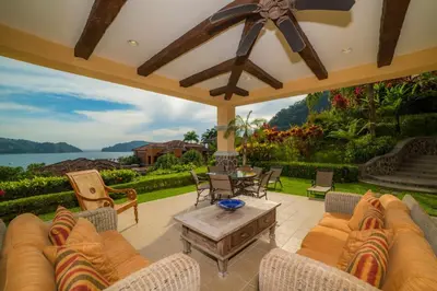a patio with a couch and chairs and a table at Marbella 1E 3 bdr Ocean View in Los Suenos in Herradura