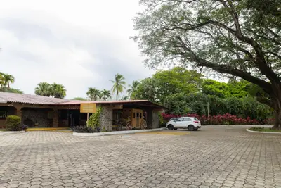 a car parked in front of a building at Hotel Las Espuelas, Bar & Restaurant in Liberia