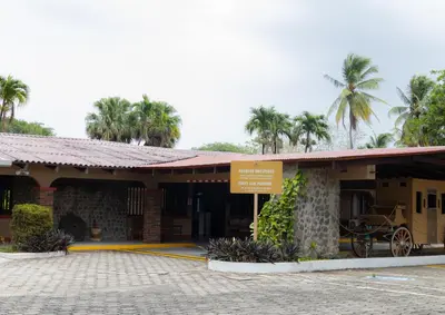 a building with a sign in front of it at Hotel Las Espuelas, Bar & Restaurant in Liberia