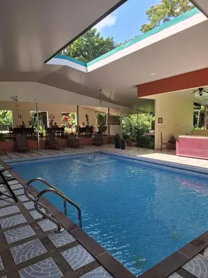 a large swimming pool in a building at Hotel San Rafael Ecolodge in San Gerardo