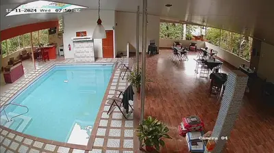 a large swimming pool in a building with a restaurant at Hotel San Rafael Ecolodge in San Gerardo