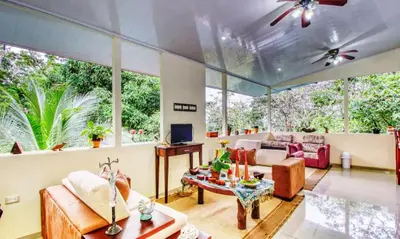 a living room with a couch and a table at Hotel San Rafael Ecolodge in San Gerardo
