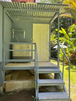 a house with stairs leading up to a door at Casas Guaney, full furnished studios! in Manuel Antonio