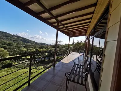 a balcony of a house with benches on it at Monteluna Studios Monteverde in Monteverde Costa Rica