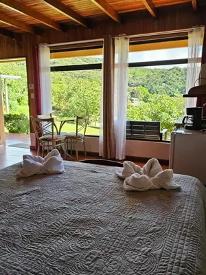 a bedroom with a large bed with towels on it at Monteluna Studios Monteverde in Monteverde Costa Rica