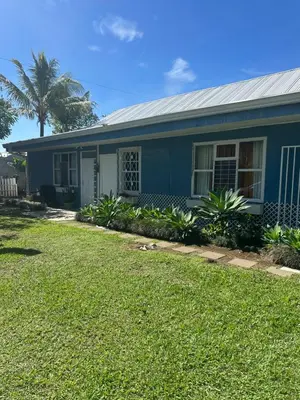 a blue house with a palm tree in front of it at CASA STELLA in Heredia