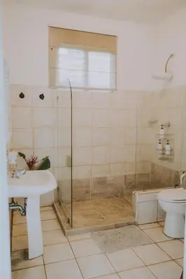 a bathroom with a shower and a sink and a toilet at CASA STELLA in Heredia
