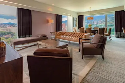 a living room with a couch and tables and chairs at Sheraton San Jose Hotel, Costa Rica in San José