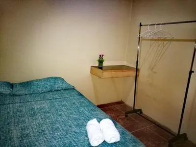 a bedroom with a bed with white towels on it at Apartamentos Morpho CR 2 in Quepos