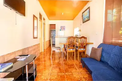 a living room with a blue couch and a table at Apartamentos Morpho CR 2 in Quepos