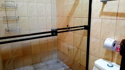 a shower with a glass door in a bathroom at Apartamentos Morpho CR 2 in Quepos