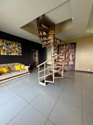 a living room with a spiral staircase and a couch at Casa Susan in San Pedrillo