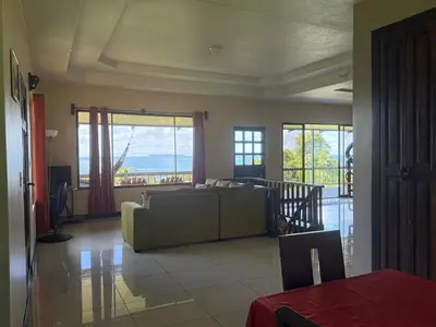 a living room with a couch and large windows at Casa Susan in San Pedrillo