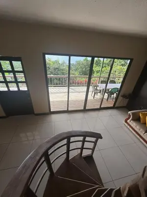 a living room with large windows and a balcony at Casa Susan in San Pedrillo
