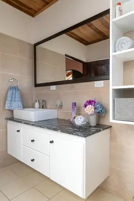 a bathroom with a sink and a mirror at Casa Sofia, a Gem Close to Orosi Thermal Pools! in Orosí