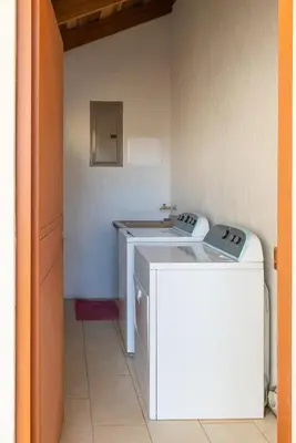 a kitchen with a washer and dryer in a room at Casa Sofia, a Gem Close to Orosi Thermal Pools! in Orosí